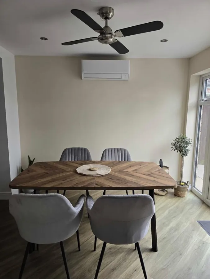 Wall-mounted split system air conditioner in a Hereford dining room