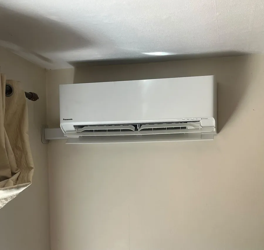 Panasonic split system air con unit with neat trunking in a bedroom