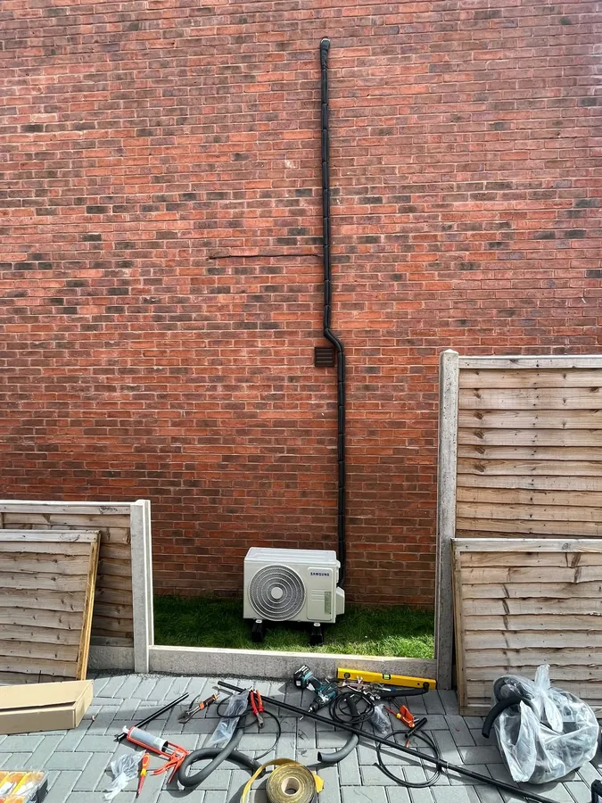 Samsung outdoor air conditioning unit with neatly trunked pipework on a brick wall