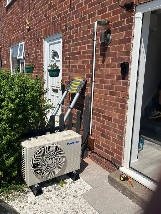 Panasonic outdoor condenser installed beside a brick house in Herefordshire