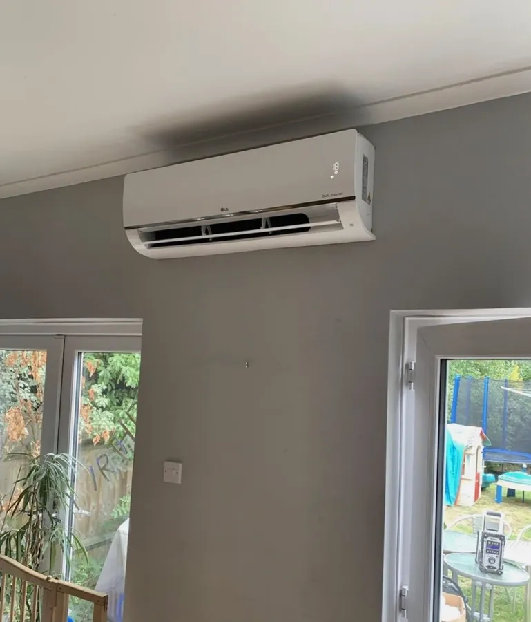LG split system air con unit above garden doors in a family room