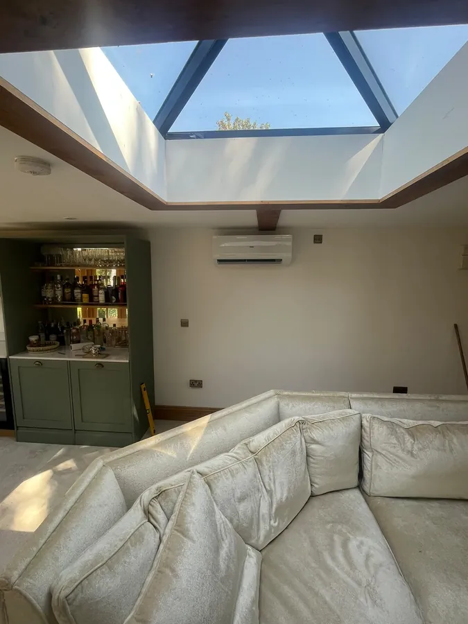 Finished indoor air conditioning unit installed in a bright Hereford lounge