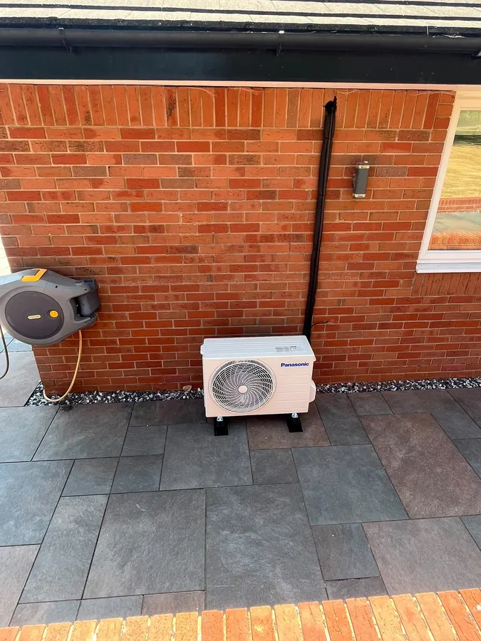 Panasonic outdoor air con unit installed beside a patio