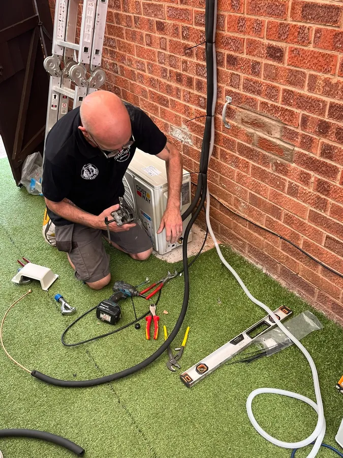 Engineer carrying out an urgent air conditioning breakdown repair